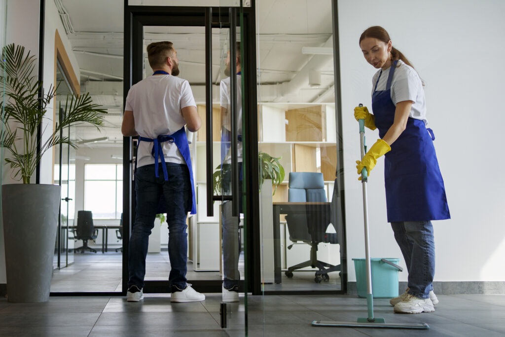 Two cleaners working in an office.